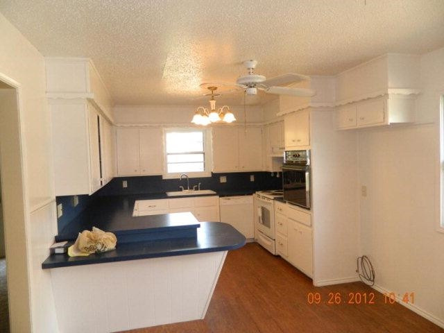 6902 Flint Avenue Lubbock, TX 79413 - Photo 3 of 10 a large white kitchen with a large window