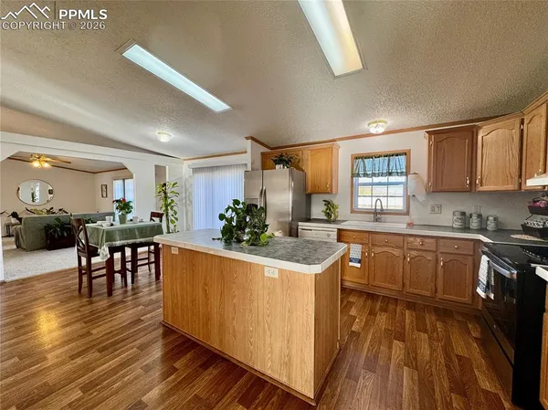 a kitchen with wooden floors and wooden cabinets