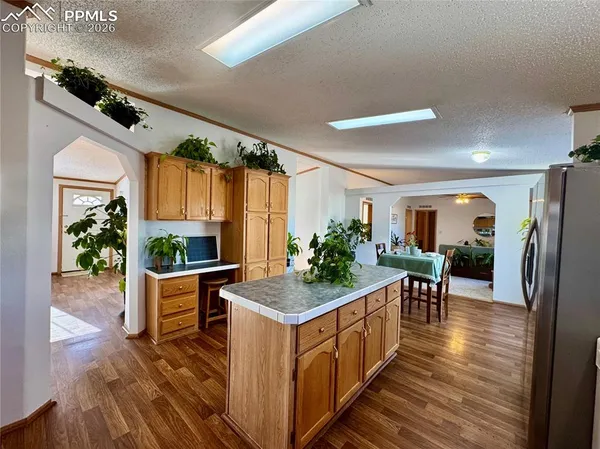 a kitchen with stainless steel appliances granite countertop sink stove and wooden floor