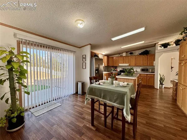 a dining room with furniture and wooden floor