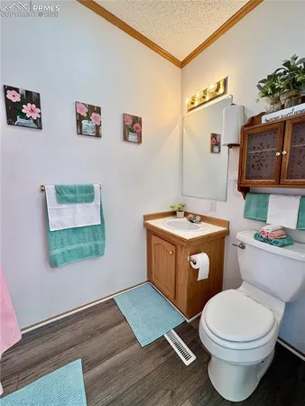 a bathroom with a toilet a sink and a mirror
