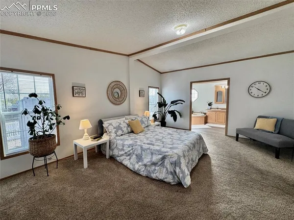 a spacious bedroom with a bed and a couch