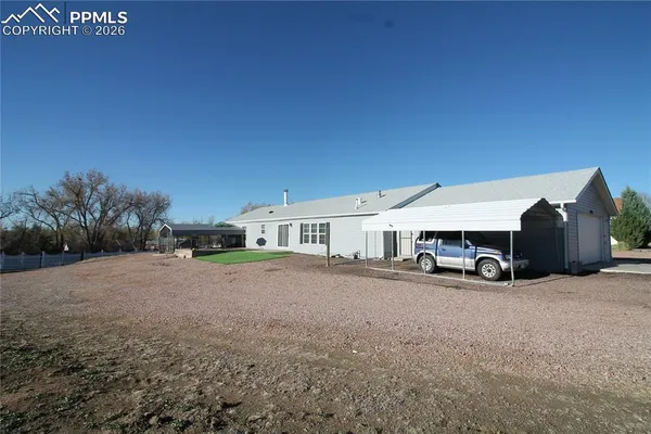 a view of a dirt road with a building in the background