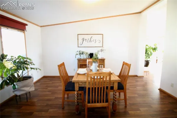 a view of a dining room with furniture and wooden floor