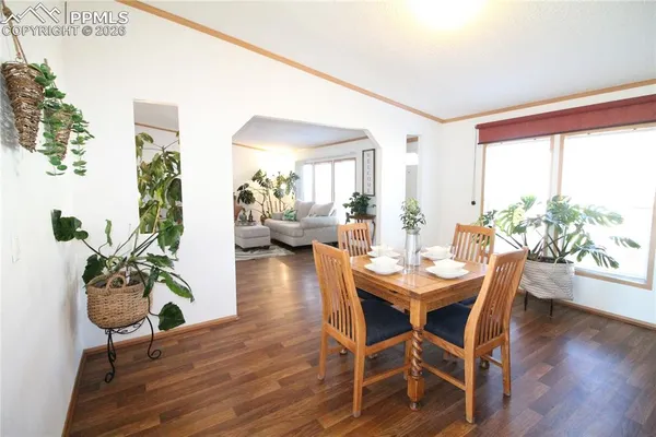 a view of a dining room with furniture window and wooden floor