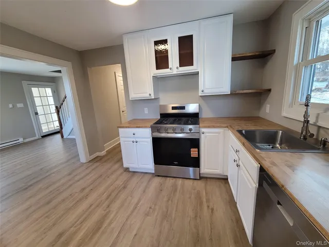 a kitchen with a sink a stove and cabinets
