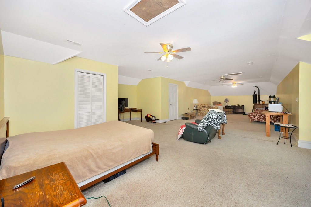 84 Scott Orchard Road Taft, TN 38488 - Photo 21 of 23 a bedroom with bed and a chandelier