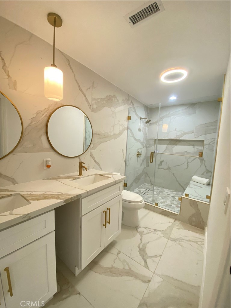 1313 West Avenue Fullerton, CA 92833 - Photo 13 of 20 a bathroom with a granite countertop sink a toilet and shower