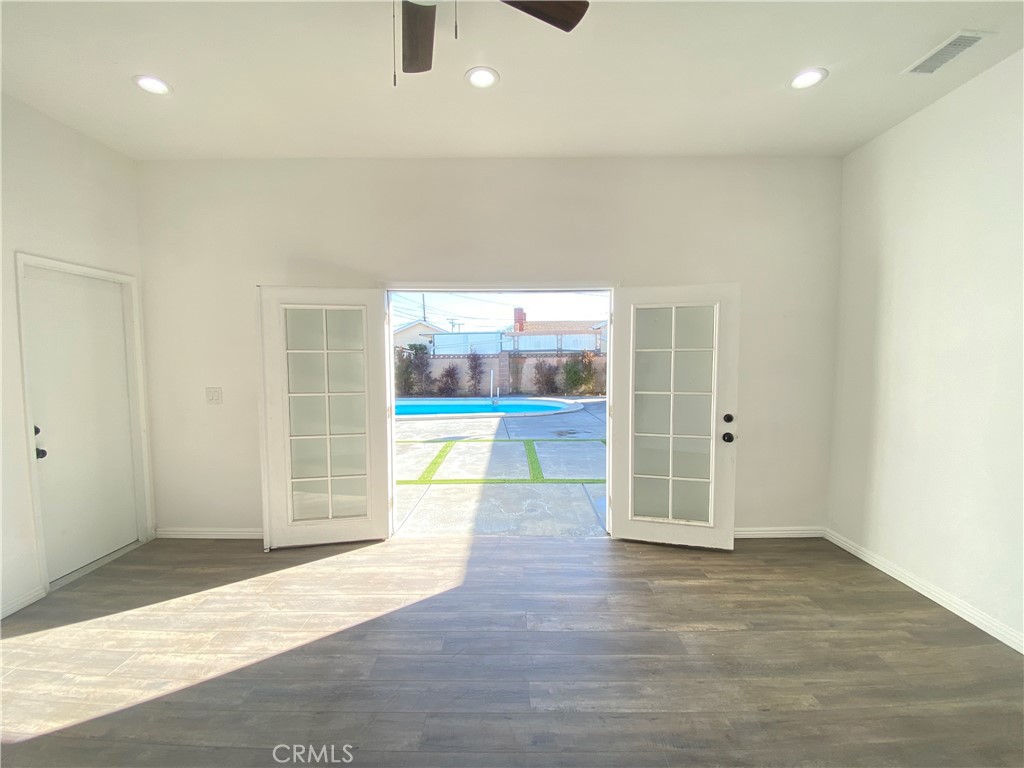 1313 West Avenue Fullerton, CA 92833 - Photo 14 of 20 an empty room with wooden floor and outdoor space