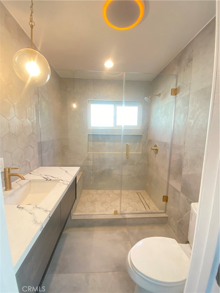 1313 West Avenue Fullerton, CA 92833 - Photo 5 of 20 a bathroom with a sink a toilet and shower