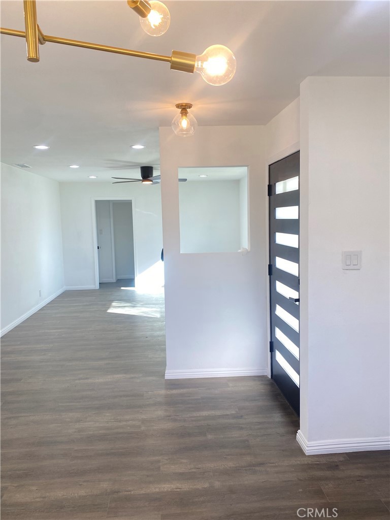 1313 West Avenue Fullerton, CA 92833 - Photo 7 of 20 a view of an empty room with a window and wooden floor