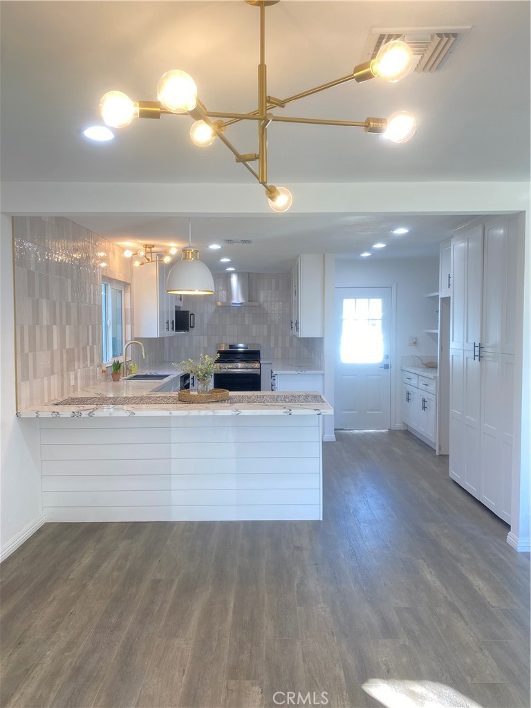 1313 West Avenue Fullerton, CA 92833 - Photo 8 of 20 a view of a living room and kitchen with wooden floor