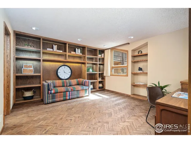 a living room with fish tank and a bookshelf