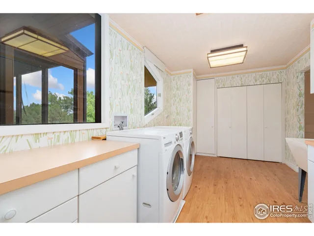 a view of a kitchen with kitchen island a sink dishwasher and a fireplace with wooden floor
