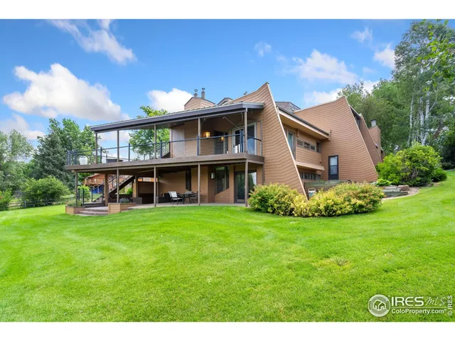 a view of a tennis ground with large trees