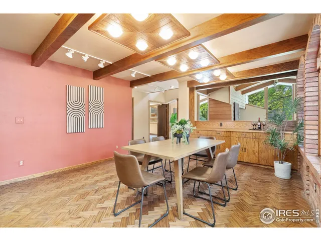 a dining room with furniture and a floor to ceiling window