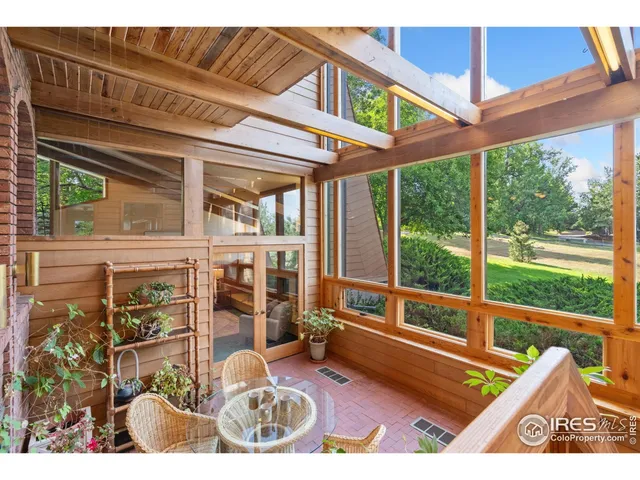 a view of a patio with table and chairs potted plants with wooden floor