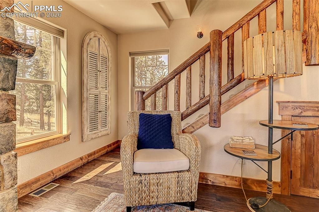 140 Dewell Road Woodland Park, CO 80863 - Photo 18 of 28 a living room with wooden floor and windows