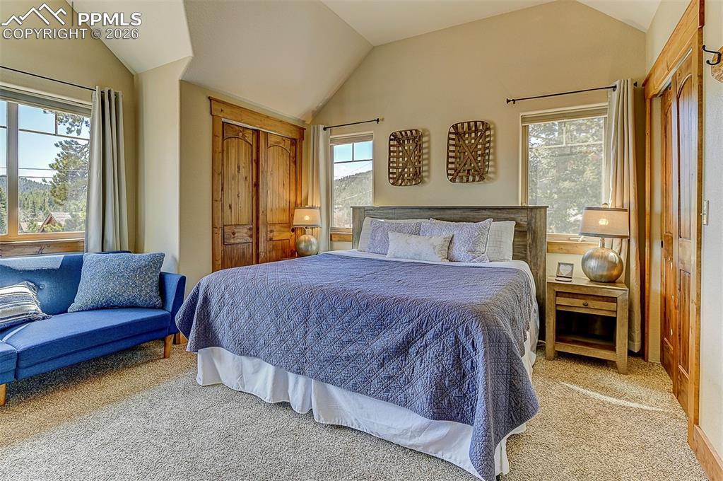 140 Dewell Road Woodland Park, CO 80863 - Photo 21 of 28 a bedroom with a large bed and a couch