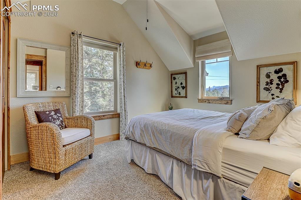 140 Dewell Road Woodland Park, CO 80863 - Photo 25 of 28 a bedroom with bed couch and window