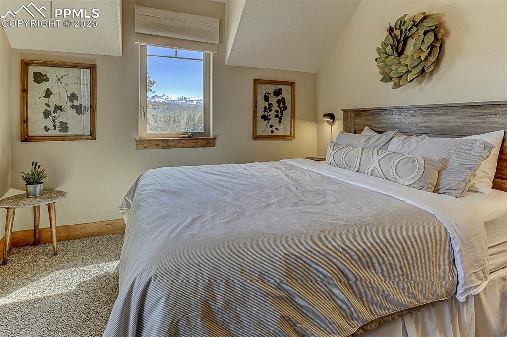 140 Dewell Road Woodland Park, CO 80863 - Photo 26 of 28 a bedroom with a bed and painting on the wall
