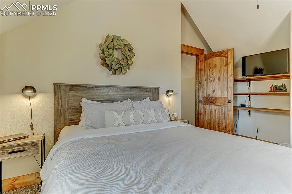 140 Dewell Road Woodland Park, CO 80863 - Photo 27 of 28 a bedroom with a bed and a flat screen tv