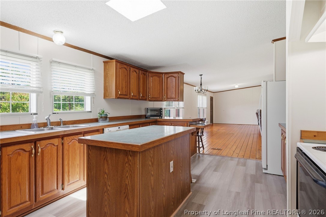 10400 Ruth Vinson Road Autryville, NC 28318 - Photo 28 of 49 a kitchen with stainless steel appliances granite countertop a sink stove and wooden cabinets