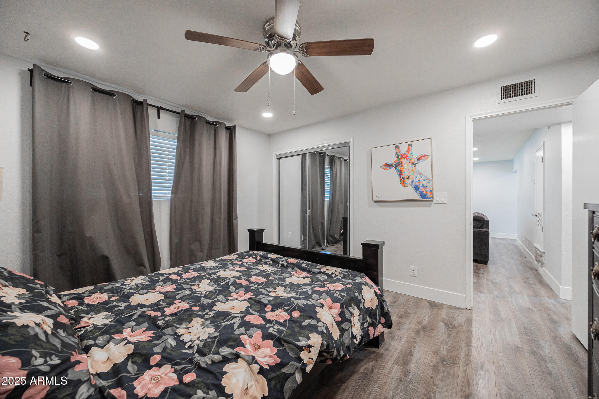 3031 South Rural Road, Unit 9 Tempe, AZ 85282 - Photo 14 of 22 a bedroom with a large bed and a chandelier