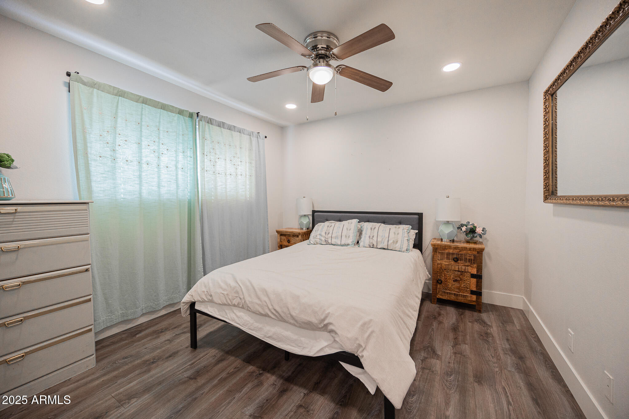 3031 South Rural Road, Unit 9 Tempe, AZ 85282 - Photo 16 of 22 a bedroom with a bed and a chandelier