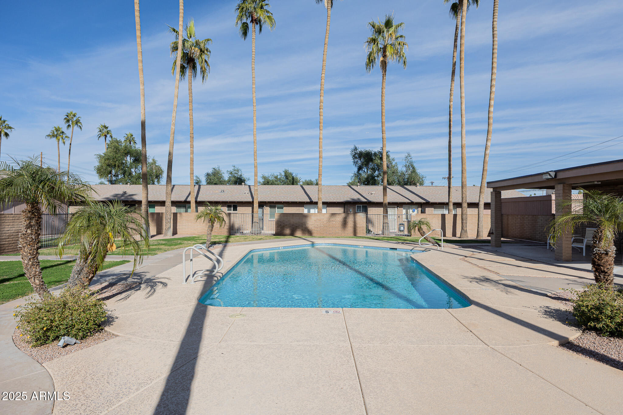3031 South Rural Road, Unit 9 Tempe, AZ 85282 - Photo 21 of 22 a view of a swimming pool with a lounge chairs