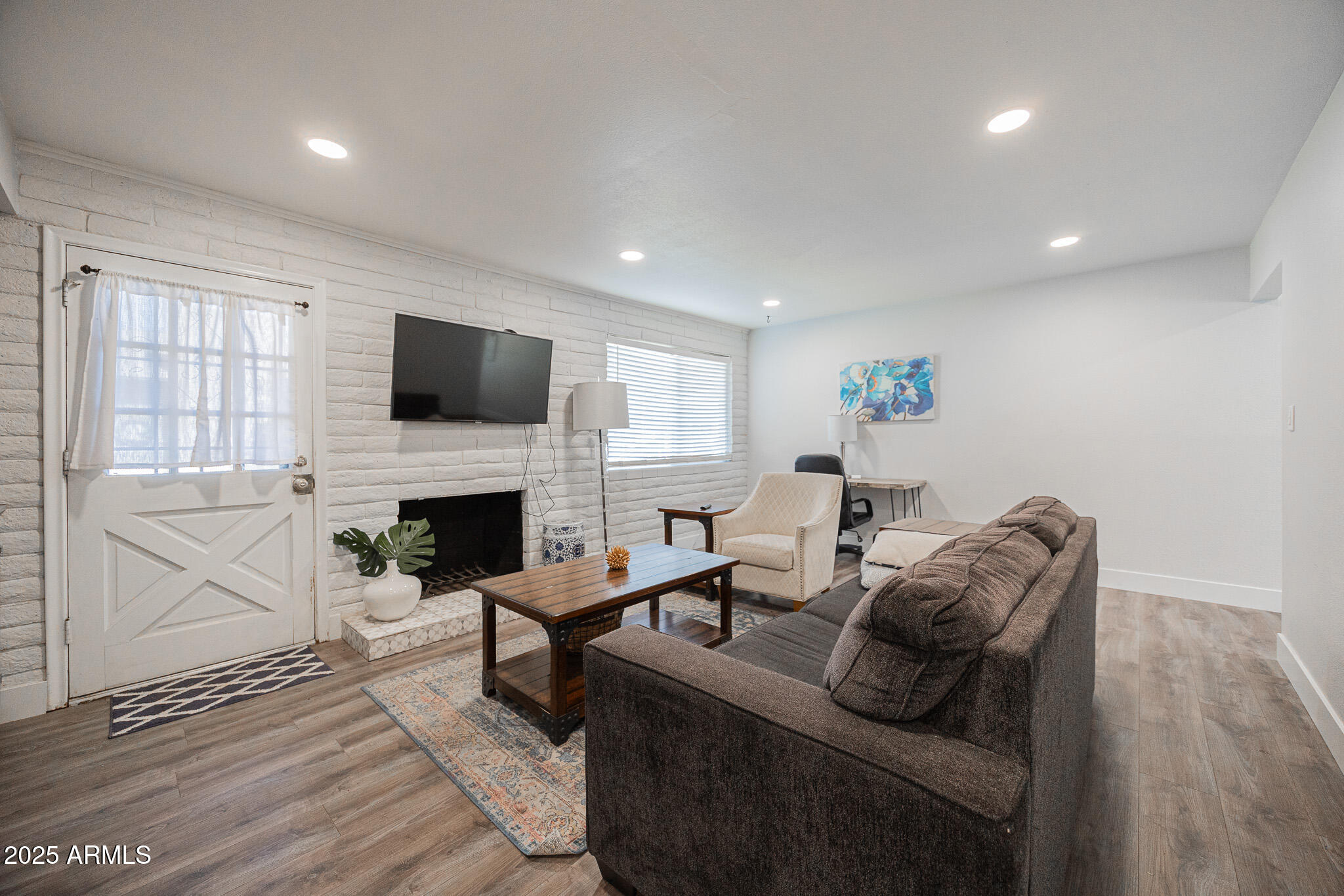 3031 South Rural Road, Unit 9 Tempe, AZ 85282 - Photo 4 of 22 a living room with furniture a fireplace and a flat screen tv