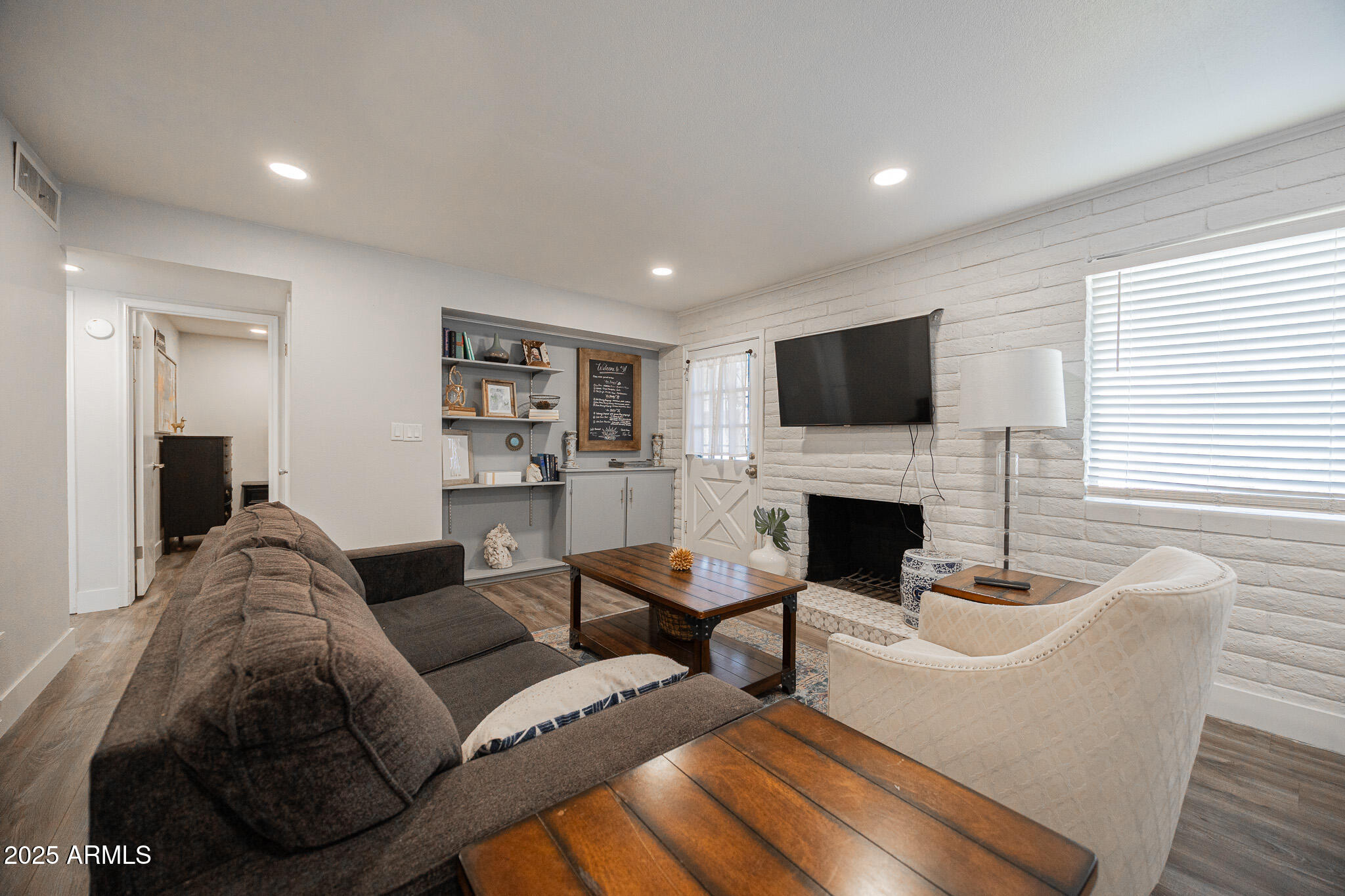 3031 South Rural Road, Unit 9 Tempe, AZ 85282 - Photo 5 of 22 a living room with furniture a fireplace and a flat screen tv