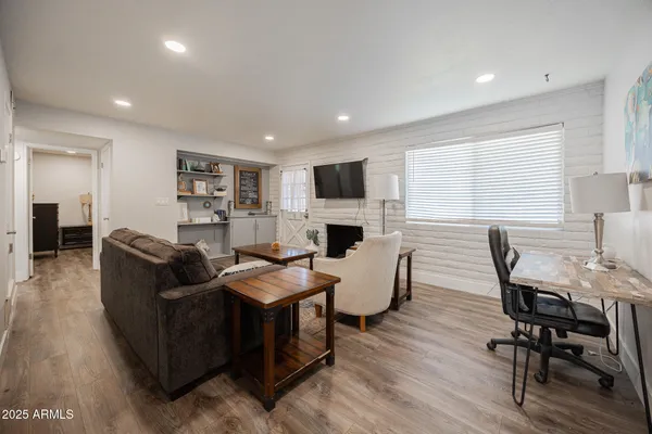 a living room with fireplace furniture and a flat screen tv