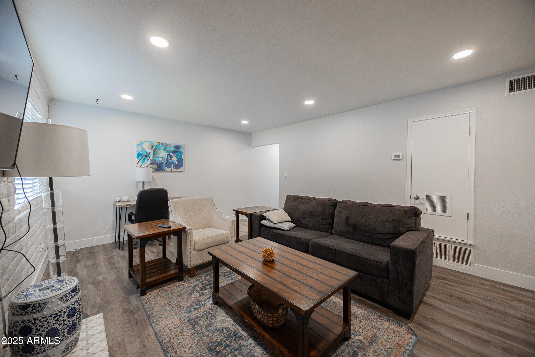 3031 South Rural Road, Unit 9 Tempe, AZ 85282 - Photo 9 of 22 a living room with furniture and a wooden floor