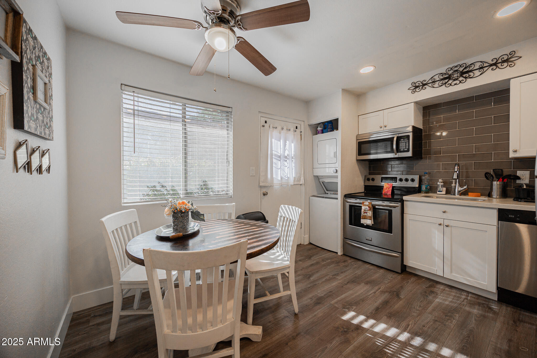 3031 South Rural Road, Unit 9 Tempe, AZ 85282 - Photo 10 of 22 a kitchen with a dining table chairs stainless steel appliances and cabinets