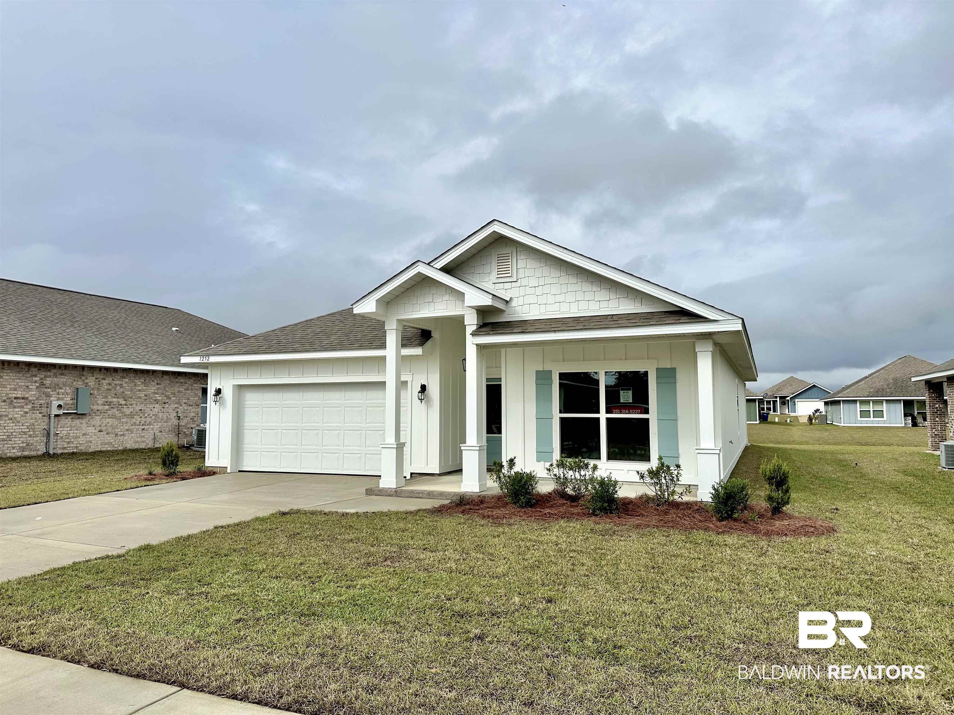 1252 Hayward Loop Foley, AL 36535 - Photo 2 of 44 View of front facade featuring a front yard and a garage