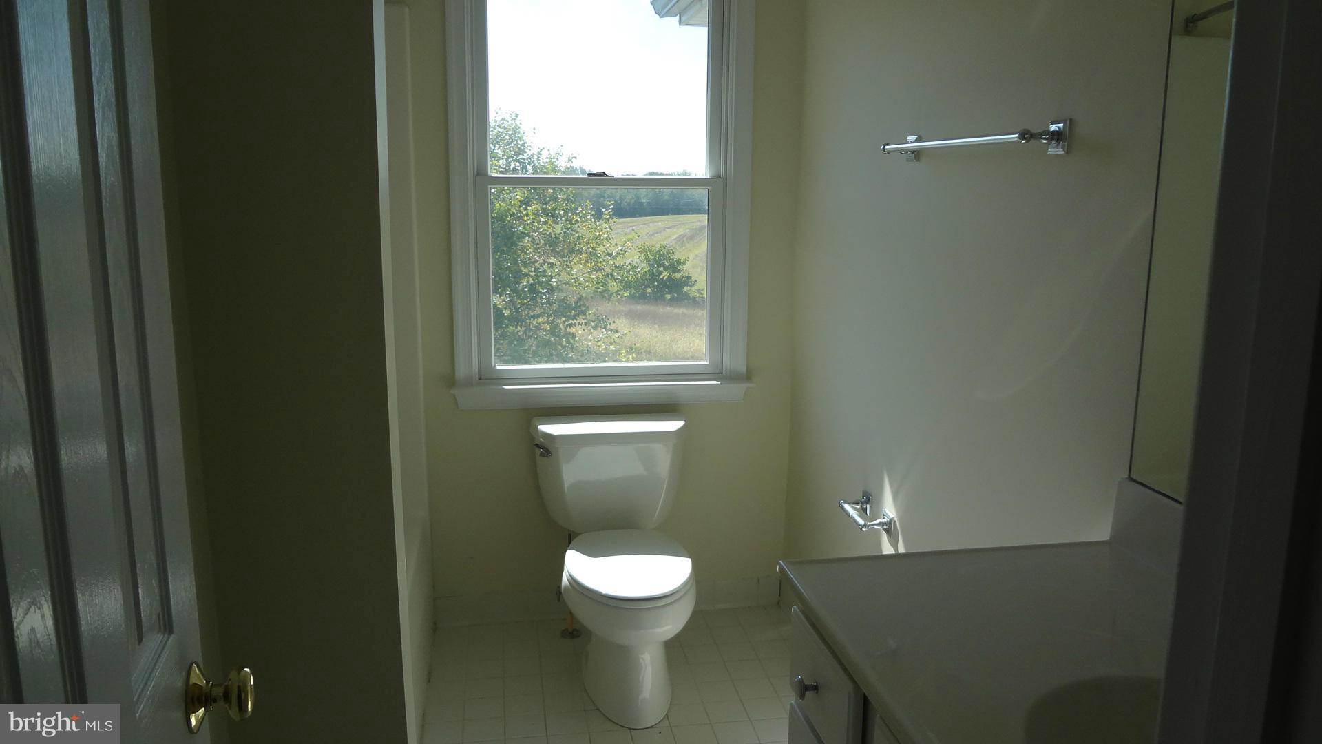 15900 Barnesville Road Boyds, MD 20841 - Photo 18 of 30 a bathroom with a toilet a sink and a window