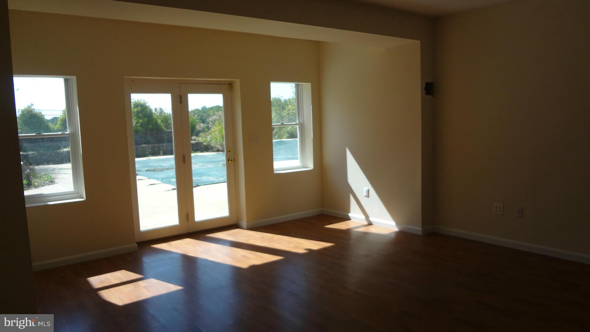 15900 Barnesville Road Boyds, MD 20841 - Photo 22 of 30 a view of an empty room with wooden floor and a window