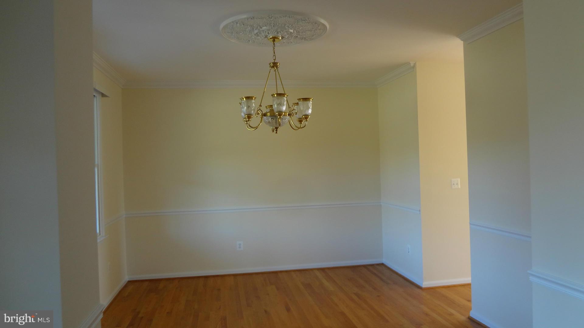 15900 Barnesville Road Boyds, MD 20841 - Photo 5 of 30 a view of a room with wooden floor and chandelier