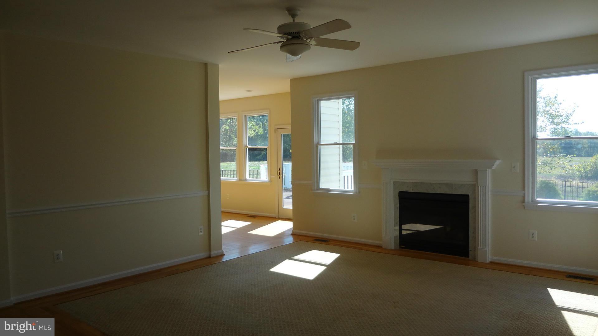 15900 Barnesville Road Boyds, MD 20841 - Photo 7 of 30 a view of an empty room with a fireplace and a window
