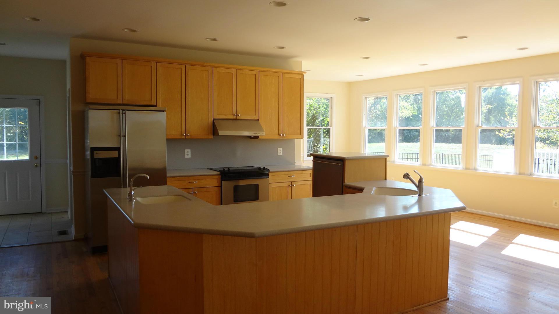 15900 Barnesville Road Boyds, MD 20841 - Photo 10 of 30 a kitchen with stainless steel appliances granite countertop a sink a stove and a refrigerator
