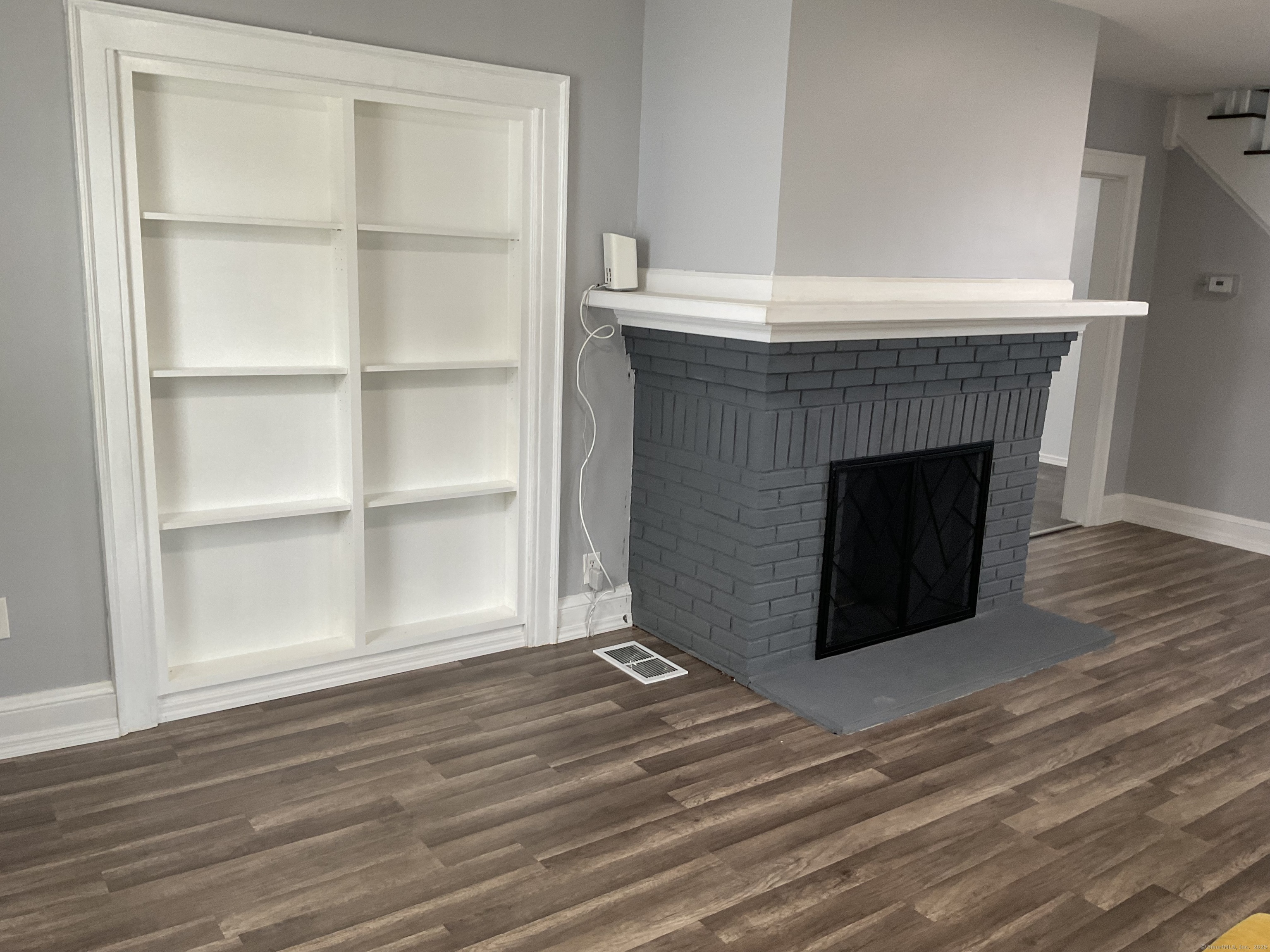 37 Westminster Street Hamden, CT 06518 - Photo 12 of 33 a room with a fireplace and a wooden floor