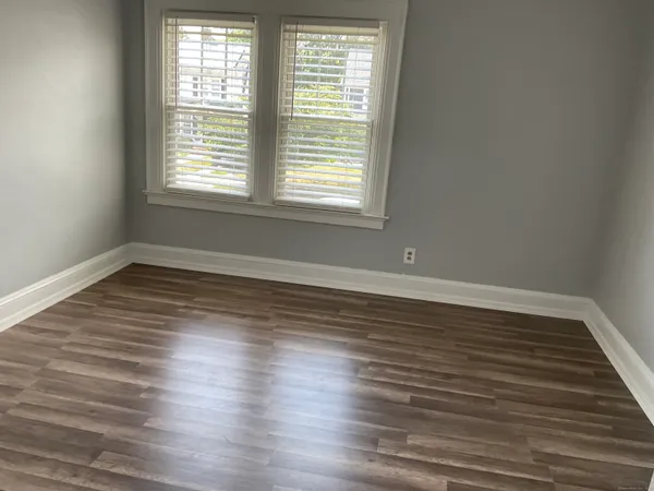 a view of a room with wooden floor and window