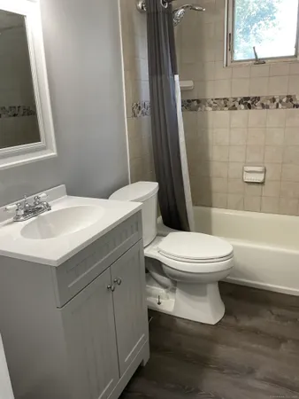 a white toilet sitting next to a bathroom sink