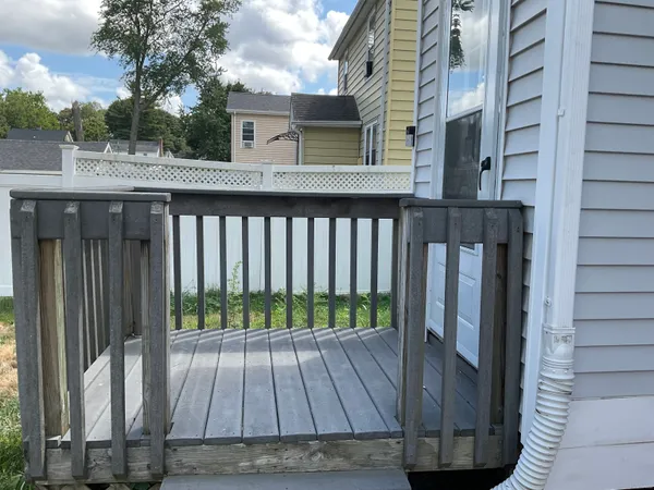 a view of backyard with wooden deck and floor