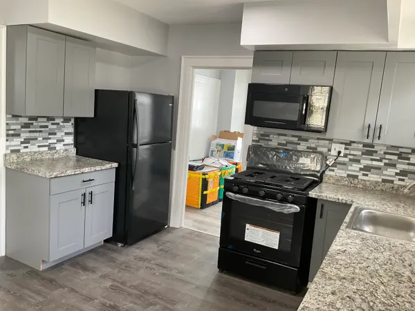 a kitchen with a stove microwave and refrigerator