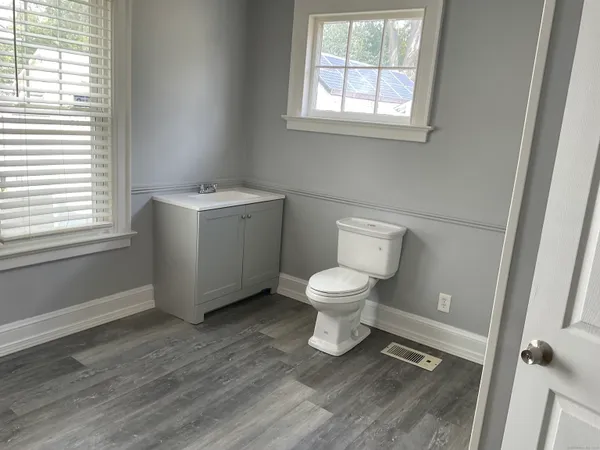 a white toilet sitting next to a bathroom sink