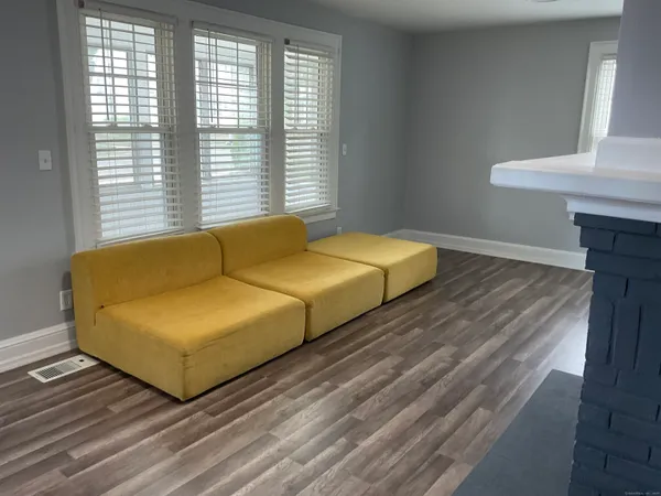 a blue bed sitting in a bedroom next to a window