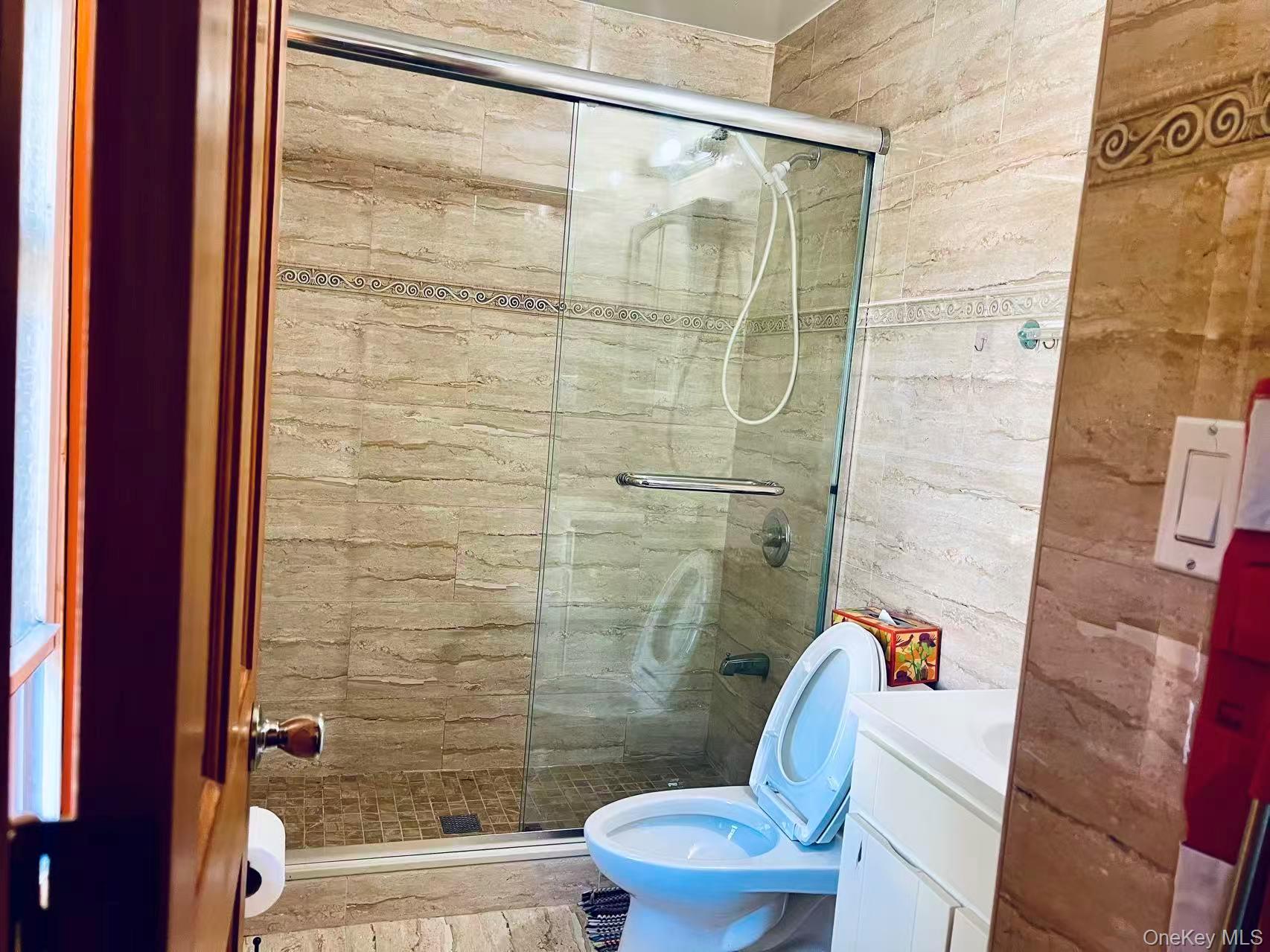 149-15 15th Road Queens, NY 11357 - Photo 11 of 20 a bathroom with a shower and a toilet