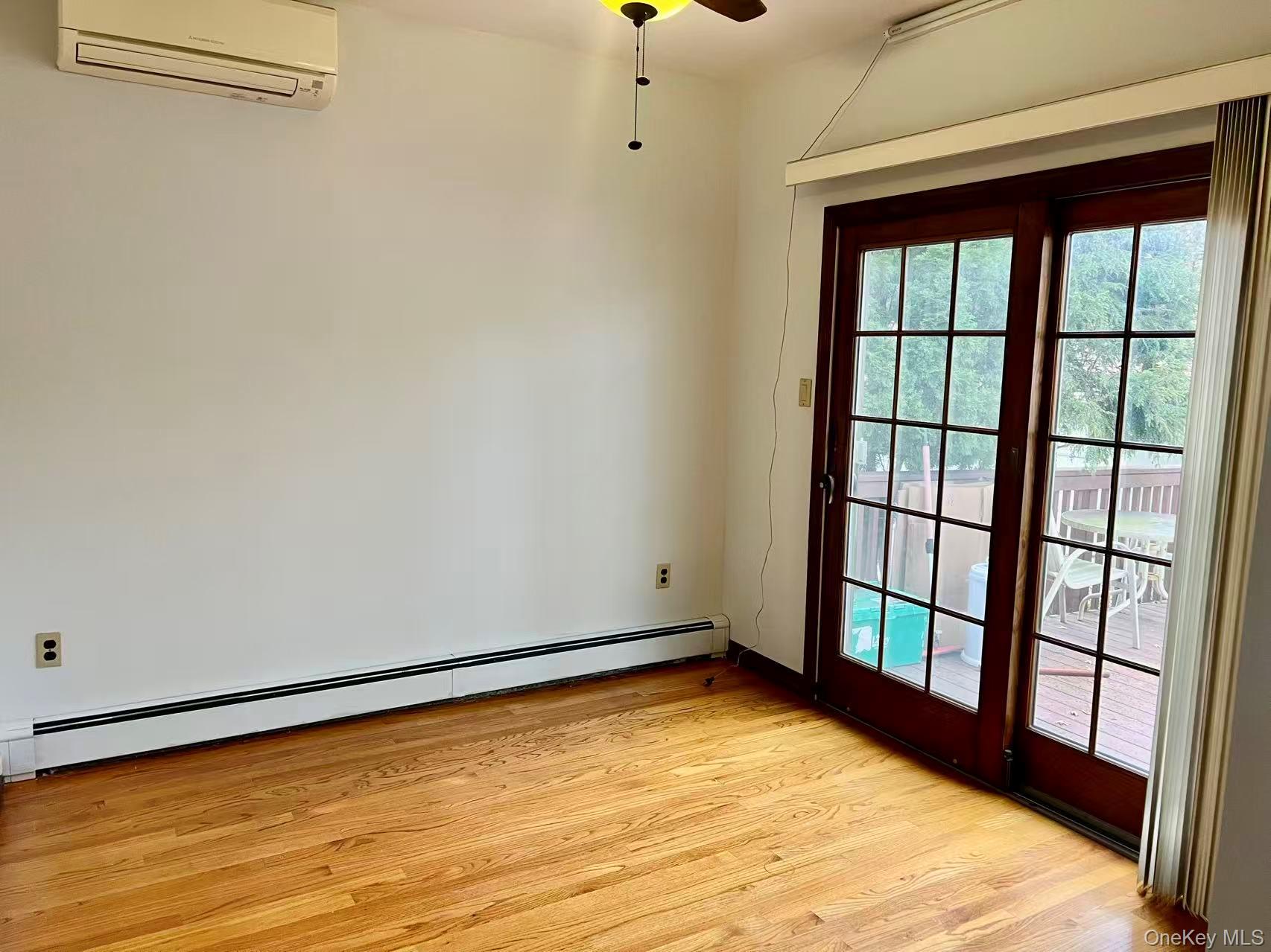 149-15 15th Road Queens, NY 11357 - Photo 12 of 20 a view of empty room with wooden floor and fan